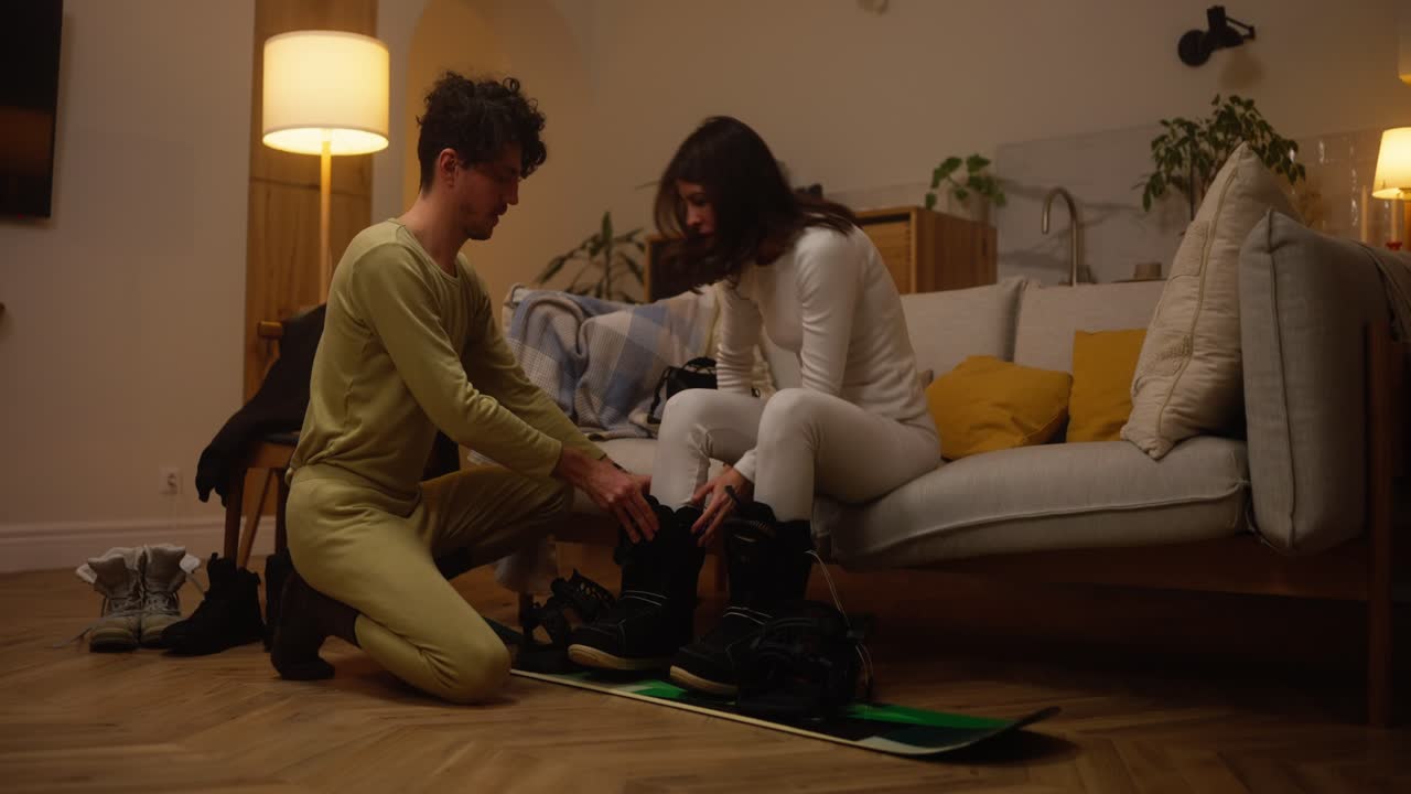 Couple getting ready for a ski trip at home