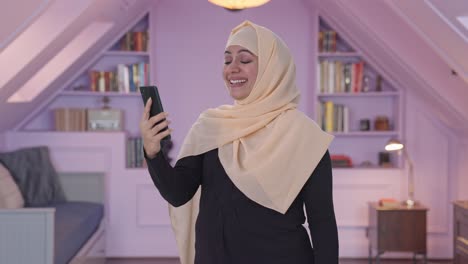 happy muslim woman talking on video call