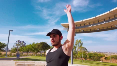 young man stretching in a park