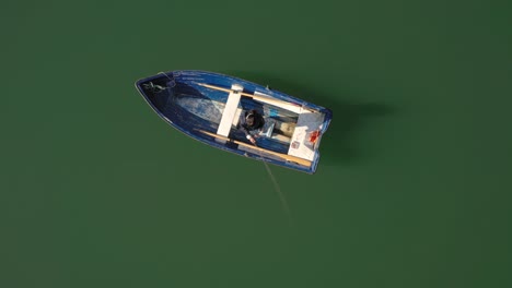 Woman-on-the-boat-catches-a-fish-on-spinning-in-Norway.