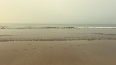 static view of the calm sea from the beach on a misty day