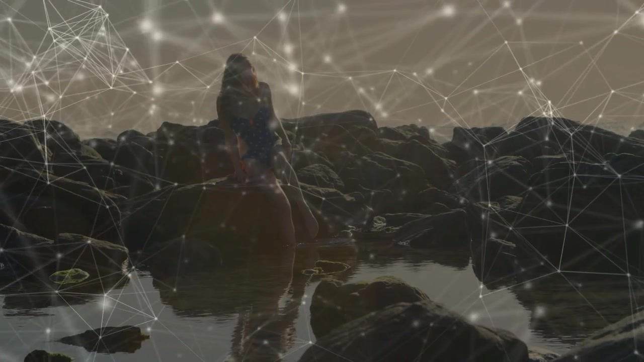 Woman pushing up on rocks and walking tide pools seeking horizon, tech network mapping motion