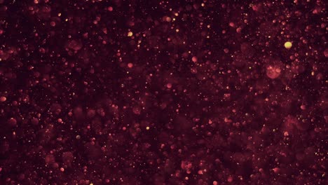 burbujas de bokeh transparentes sin costuras que se levantan suavemente en el aire sobre el fondo del cosmos rojo oscuro, brillando.