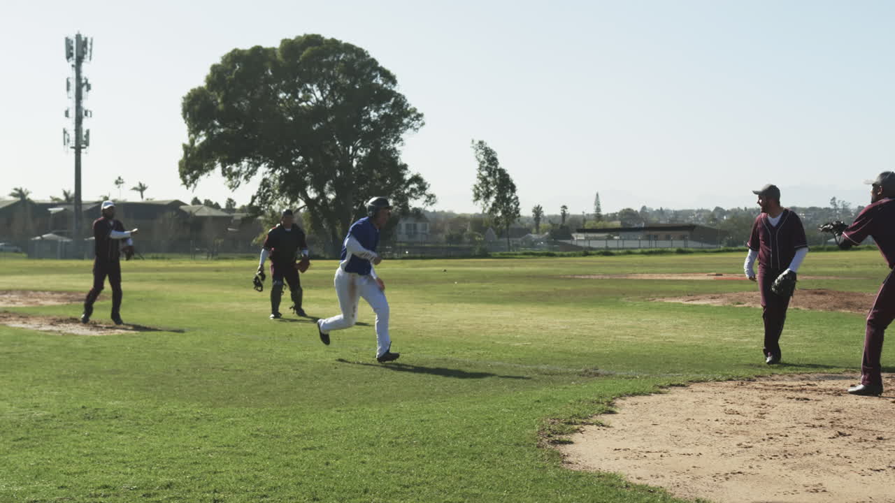 Multiracial male baseball players, catching and throwing the ball, running on a pitch, slow motion