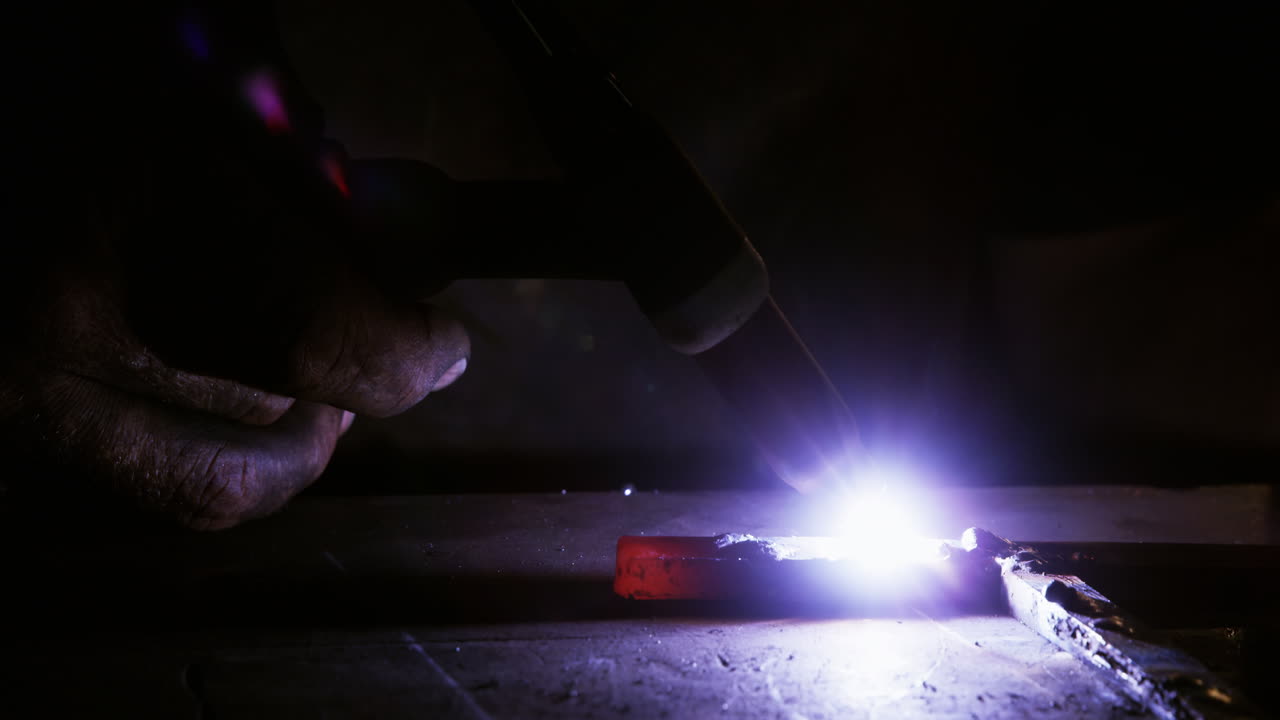 Close-up of welder using welding torch