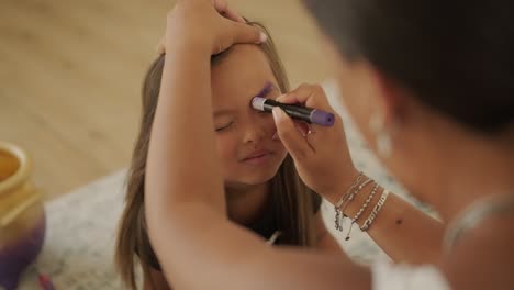 little girl getting face painted for halloween