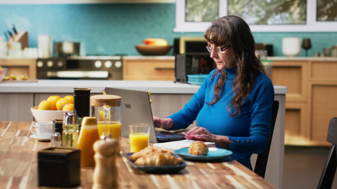 Senior married couple writing a grocery list together on textbook