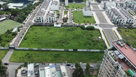 drone dolly above open green space in urban district 2 ho chi minh city vietnam