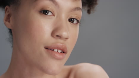 close up portrait beautiful mixed race woman touching face with hand caressing smooth healthy skin complexion perfect natural skincare gorgeous feminine beauty concept on grey background