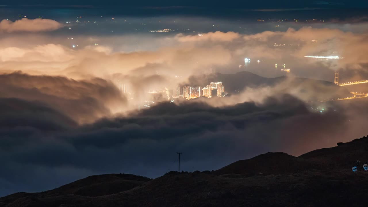 Night Time Lapse zoom over Tai Mo Shan, Hong Kong with clouds moving. Beautiful night city lights of Tai Mo Shan ,cityscapes at mountain in Hong Kong. Time lapse clouds on the top of mountain