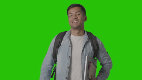 Portrait-Of-Smiling-Male-University-Or-College-Student-With-Laptop-Against-Green-Screen-1