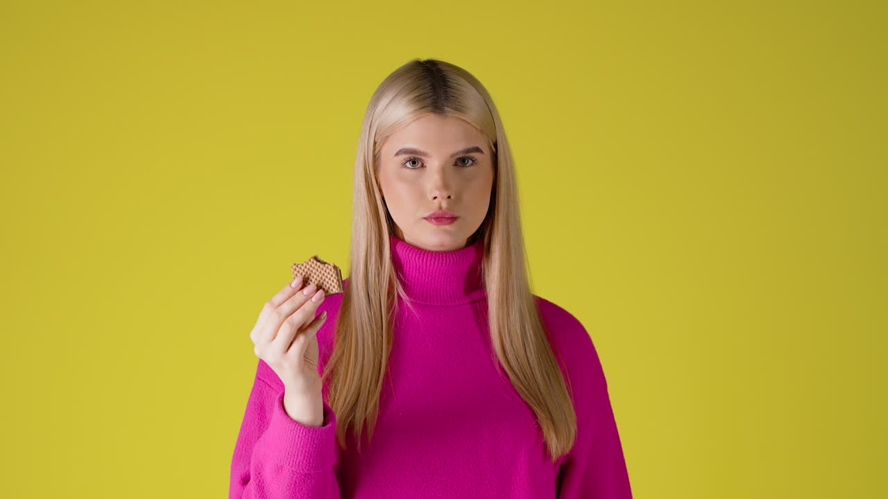 Young Blonde Woman Eating a Waffle
