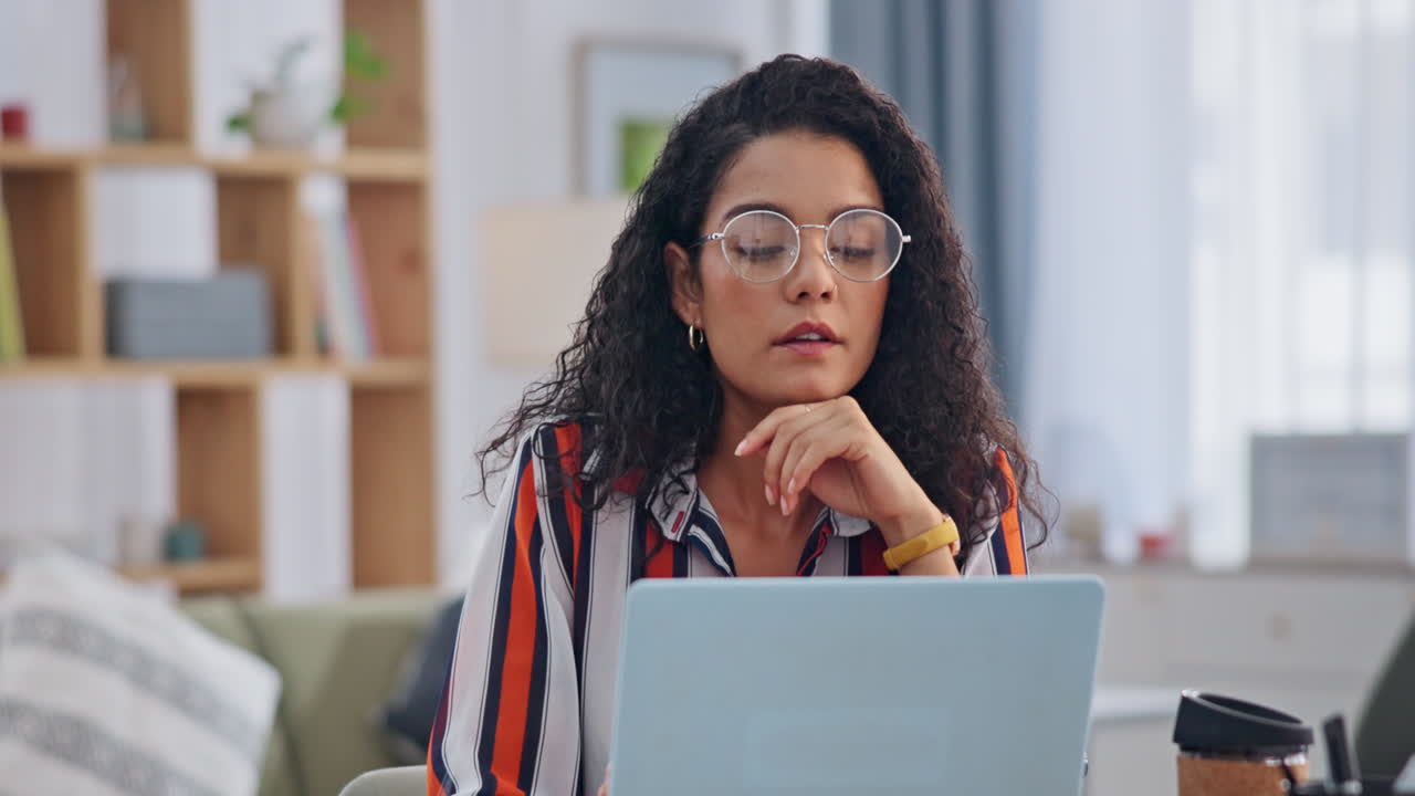 Woman Concentrating on Laptop at Home
