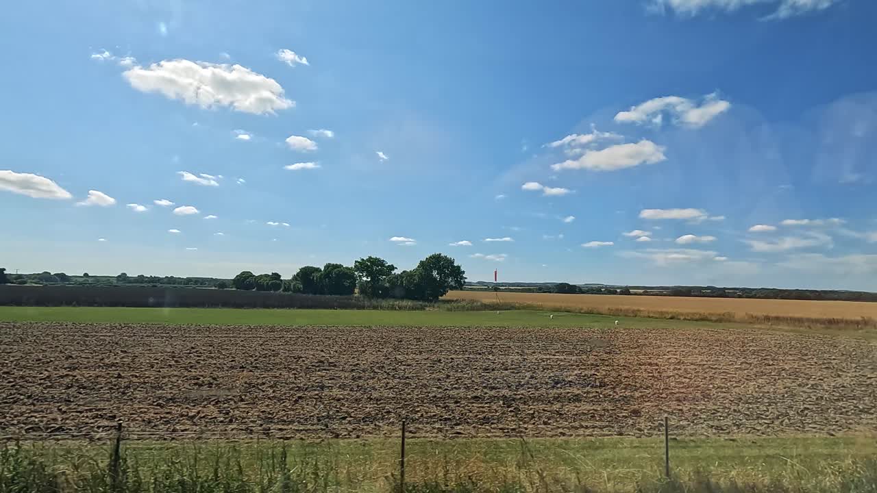 Expansive fields under a clear blue sky