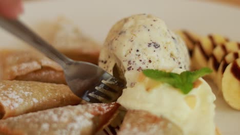 forking dessert with ice cream and pastries