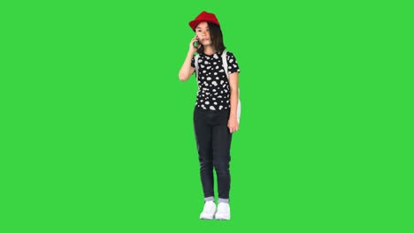 young asian girl talking on smart phone on a green screen, chroma key