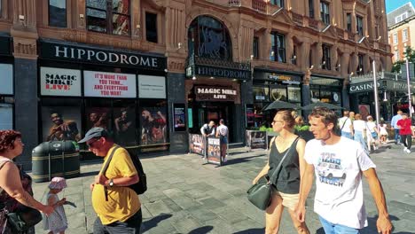 people walking past the hippodrome in london