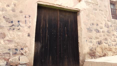 old wooden door in an old village in the middle of the desert with the style of arab house