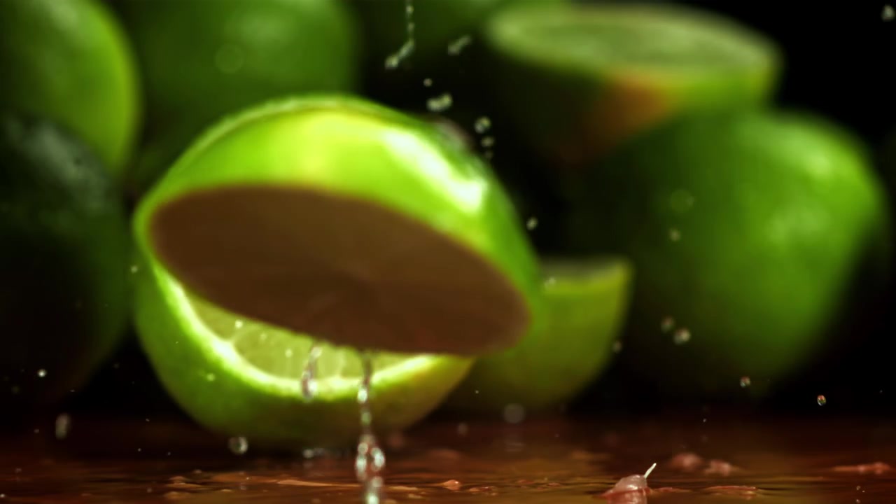 Fresh Lime Sliced in Slow Motion with Water Splashing
