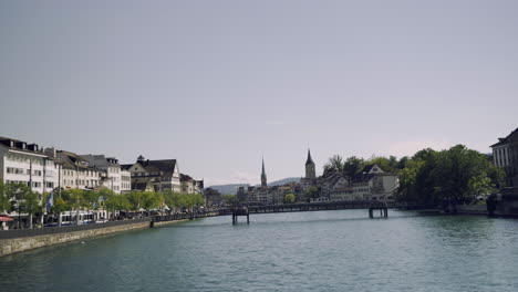 historic city center of zurich with famous fraumunster church on river limmat on a sunny day with blue sky, canton of zurich, switzerland