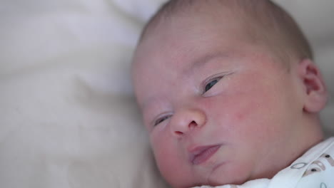 cute infant young child lying at the back. portrait of little newborn in white cloth.