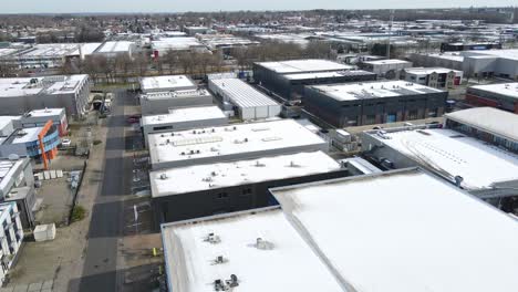 jib up of large industrial zone with snow covered rooftops