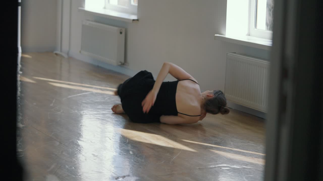A woman is dancing in a room