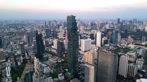 drone shot of mahanakhon tower skywalk, rooftop, in bangkok, silom area, business district, downtown