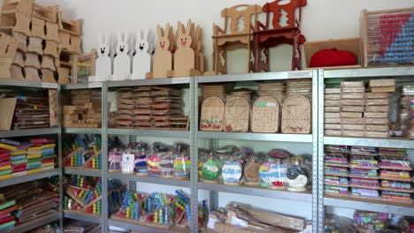 wooden games wrapped, stored on shelf in small game factory, ready for shipping