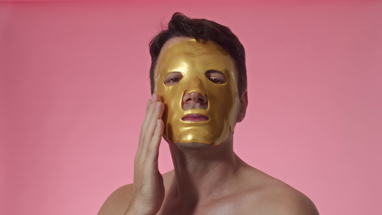Man Wearing Golden Hydrating Sheet Mask on Face