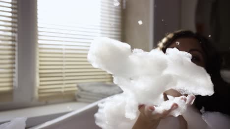 woman enjoying a relaxing bath with bubbles