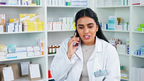 pharmacist behind a drugstore counter talking to
