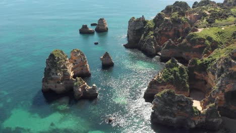 lagos, algarve - ascending shot of majestic cliffs and turquoise ocean