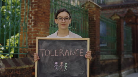 Woman Holding Chalkboard with Tolerance Message