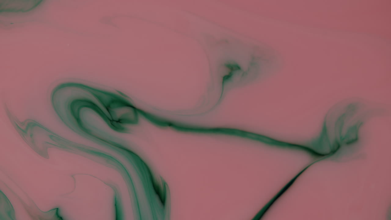 Top down shot on ink experiment looks like delicious soup with creative inlay or fish tail moving through left corner of picture