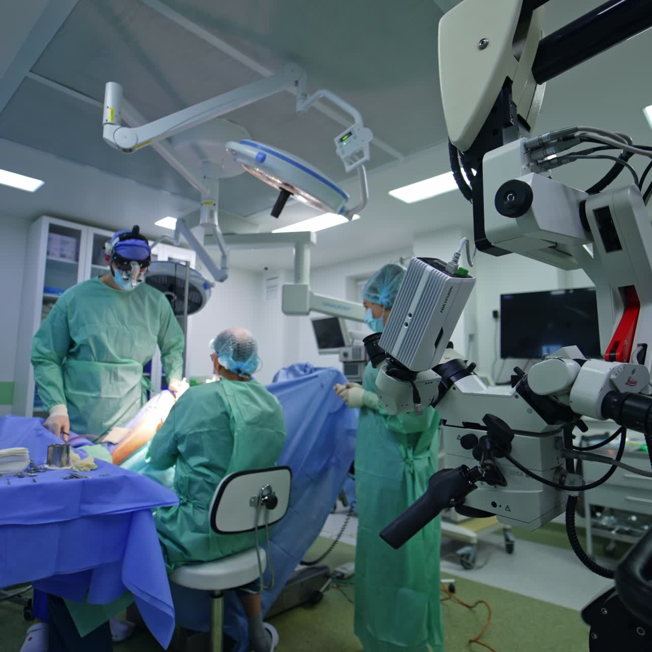 Neurosurgical operation taking place in modern operational room. Powerful microscope for high-precise surgeries at foreground