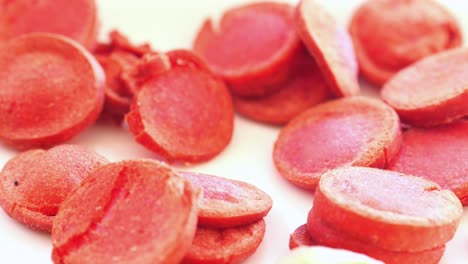 sliced red dog treats on a plate