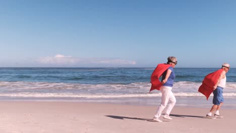 elderly couple running dressed like superheros