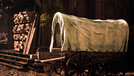 antique conestoga wagon in a rustic setting