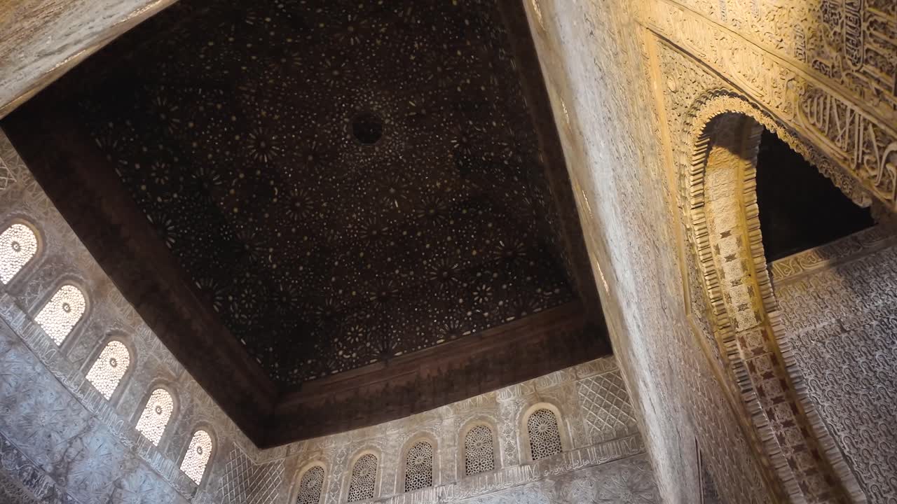 Orbital shot observing the interior details of the walls and ceiling of the Hall of the Ambassadors in the Nasrid Palaces of the monumental Alhambra complex in Granada, Spain