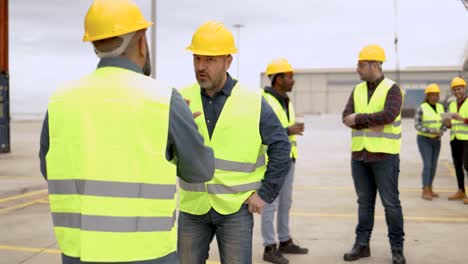 engineer people working at shipping containers port terminal - freight logistics operator