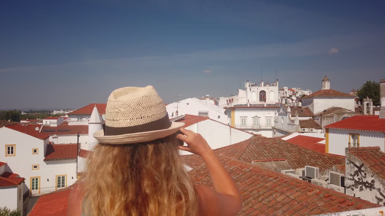 Woman Takes Panorama Photo of Historic Town
