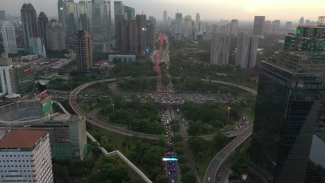 sunset time jakarta city downtown busy traffic street road junction aerial panorama 4k indonesia