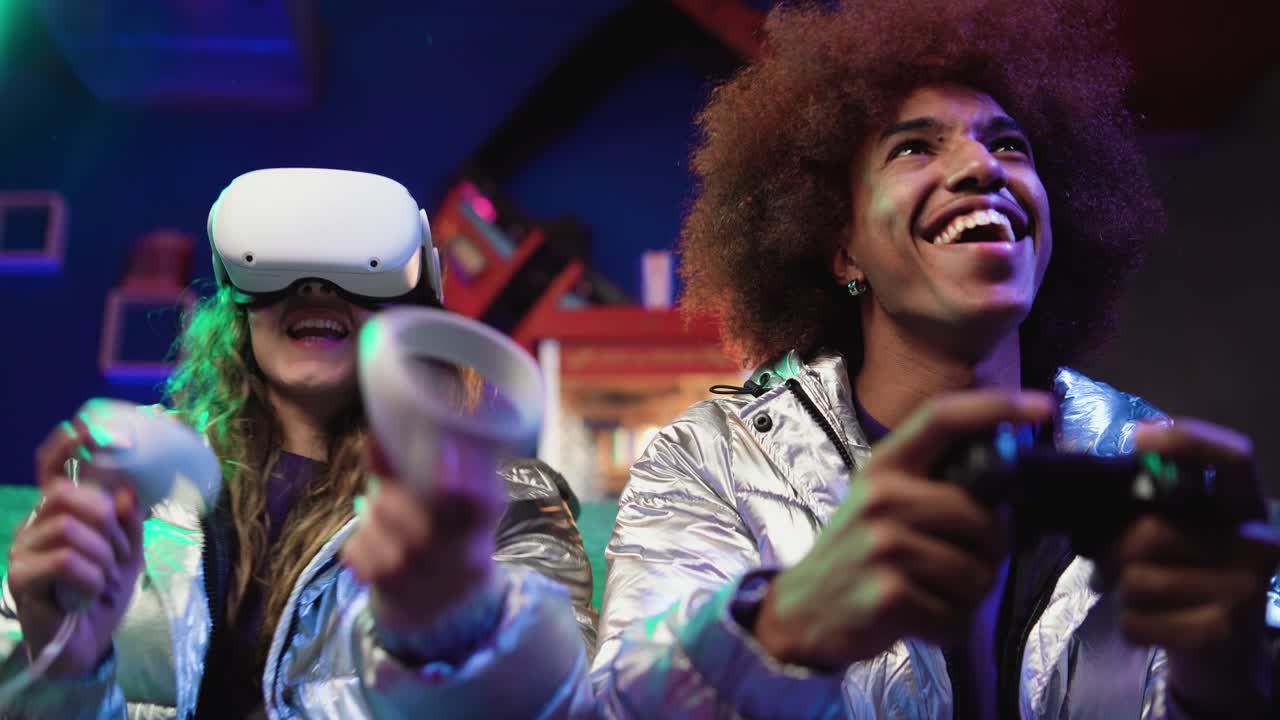 jugadores de video masculinos y femeninos en ropa futurista en el sofá