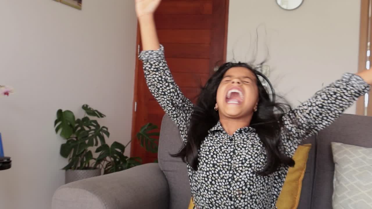 Energetic Young Girl Screaming with Joy While Listening to Music