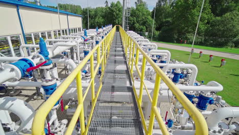 steel walkway over the distribution pipeline system at compressor station facility