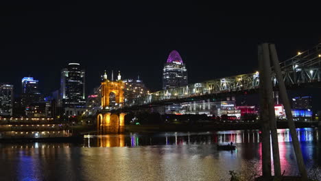 time-lapse of riverboats on the ohio river in front of cincinnati city, night