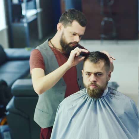 barber cutting hair for client in a barbershop 02