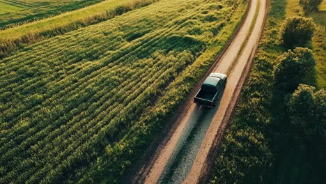 pickup truck on a country road through fields