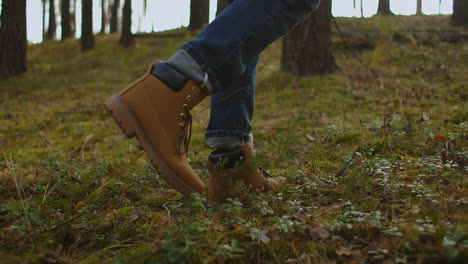 man walks along the mountains to the top. tourist in boots going along the stone road on the background a beautiful landscape. travel concept active people on the way to victory move forward close up. high quality 4k footage